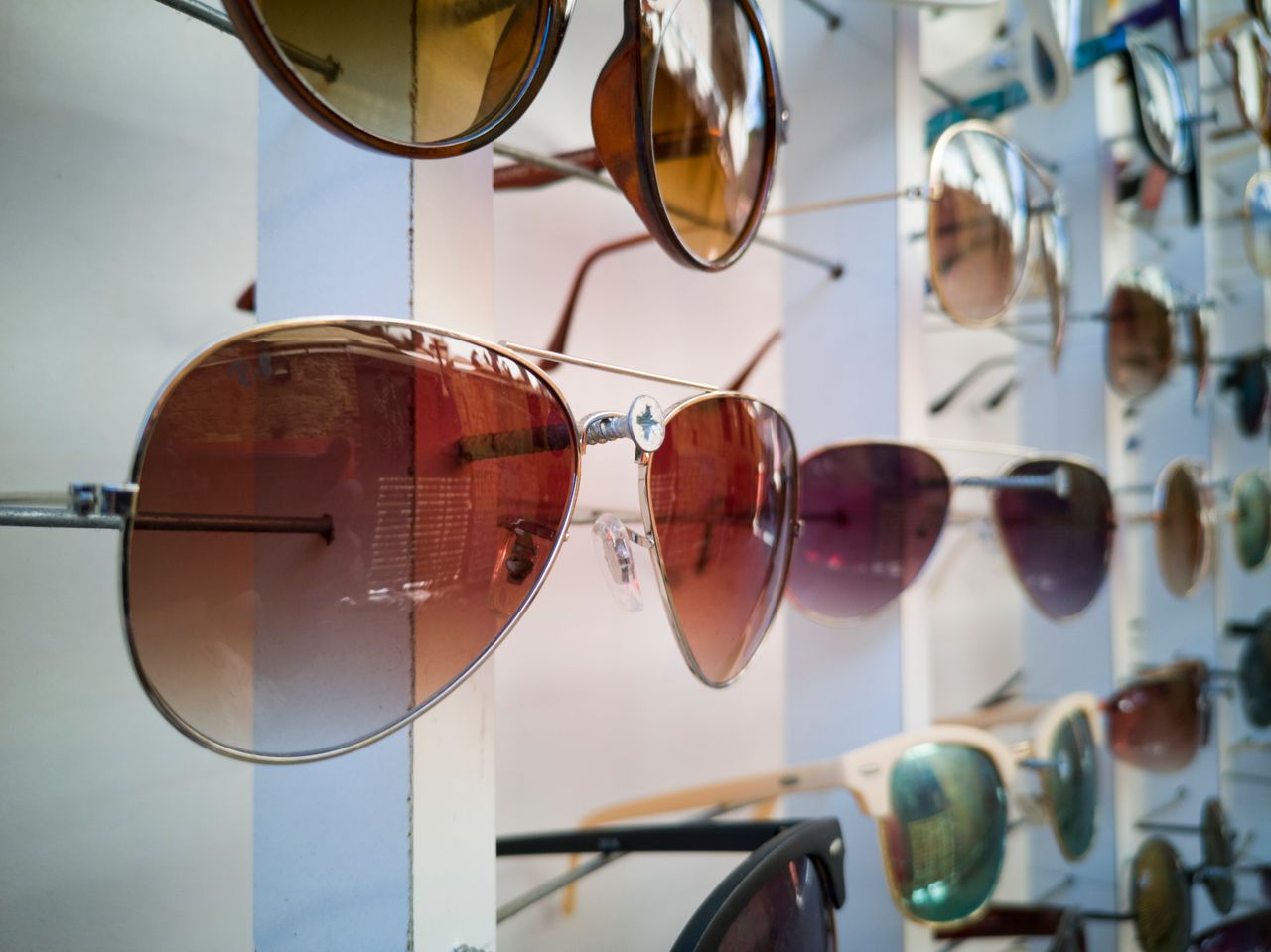 services-05 A vibrant display of sunglasses with various styles epitomizing modern eyewear fashion.